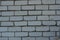 Unusual construction background, white bricks smeared with gray cement, not professional and uneven.