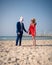 Unusual couple have marriage on the beach.