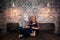 Unusual couple reading a book in stylish apartment