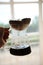 Unusual creative coconut shell pourover drip alternative coffee brewing in hand