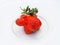 Unusual deformed fresh raw organic strawberries, on a white plate