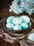 Unusual Easter on dark old background. Ceramic brown bowl with blue eggs. Darkness, rays of sunlight