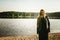 Unusual Gothic girl with long red hair reflects at lake