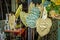 Unusual handmade clay fairy and Greenman garden stakes on display in the springtime