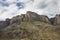 Unusual mountain rocky landscape, sheer cliffs against the backdrop of a cloudy sky