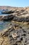 The unusual porous structure of the stone volcanic coast of the island of Comino, Maltese archipelago.