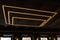 Unusual rectangular design lamps on the ceiling in an expensive restaurant. Interior design in a cafe. Lighting fixtures on the