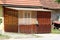 Unusual retro vintage small suburban attached family house porch closed on all sides with various type of wooden board designs