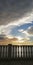 Unusual spiral clouds against the backdrop of the sea sunset and the classic balustrade. Beautiful alarming admiring natural