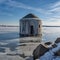 Unusual strange landscape, empty houses in the river covered with ice,