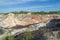 Unusual surreal alien landscape. Orange mountains and river. Ural refractory clay quarries