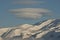 Unusual UFO shaped cloud over the Antarctic mountains winter day