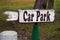 Unusual unique hand painted car park sign with pointing finger