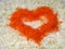 Unusual vegetable background with cabbage and carrots in heart shape on Valentine`s Day.