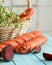 Unusual vegetable bread with beetroot. Broken loaf of bread on rustic table with basket of daisies on blurred background