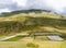 Unusual view featuring green and white. Rocky mountain and fields in the valley, Castelluccio di Norcia, in Umbria