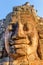 Unusual view of giant stone face of Bayon temple, Angkor