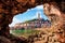 Unusual view with old clock towe in Piran through a rock hole. the tourist center of Slovenia. popular tourist attraction.
