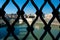 Unusual view from Ponte San Angelo of the basilica of San Pietro and the Tiber river behind the grates