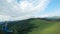 Unusual view of a woman riding a zip line among the mountains. Fast and maneuverable flight around a person. Filmed on