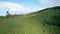 Unusual view of a woman riding a zipline among the mountains. Fast and maneuverable flight around a person. Filmed on