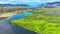 Unusual volcanic lava plain landscape, Volcanic mountain covered with green moss in early spring, Clear glacier river