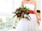 Unusual wedding bouquet at hands of a bride