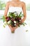 Unusual wedding bouquet with succulent flowers at hands of a bride