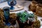 Unusually decorated table. Blue glass water or wine , moss and succulents.A romantic and fancy dinner