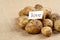 Unwashed potatoes on a rough old cloth on it is a leaflet with the inscription love