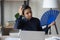 Unwell Indian woman wave with hand fan at workplace