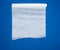 Unwound white parchment baking paper on a blue background