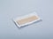 Unwrapped stick of chewing gum on light grey background