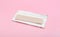 Unwrapped stick of chewing gum on pink background