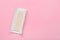 Unwrapped stick of chewing gum on pink background, top view. Space for text