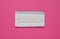 Unwrapped stick of tasty chewing gum on bright pink background, top view