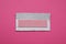 Unwrapped stick of tasty chewing gum on bright pink background, top view
