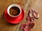 Ð¡up of black coffee with red leaves. Fall composition