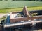 Up close aerial drone view of a barn conversation showing scaffolding and brickwork