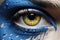 Up-close image of a female eye covered in yellow-blue paint, serving as a representation of the issues confronting Ukrainians and