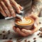 An up close shot of a barista creating latte art with the capti