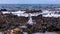 Up close shot of a tine blowhole producing stream of bubbles in a tide pool.