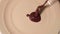 Up and close up view of cook`s hand putting chocolate sauce on yellow plate. Dessert time