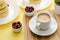 Ð¡up of coffee and berries on yellow background. Syrniki. Russian food. Copy space.