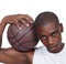 Up for a game. Studio portrait of a young basketball player standing with his basketball.