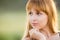 Up portrait of a girl gazing to left, creating a soft green background