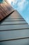 Up view on modern business office building and sky on the background. Urban exterior and tall perspective.