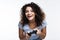 Upbeat curly-haired woman playing video games