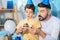 Upbeat father and son blowing out candle on birthday cake