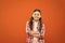 Upbringing versatile personality. Childhood concept. Girl child stand orange background. Happy childhood. Grow mentally